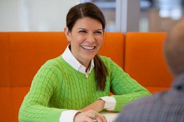 female employee office laughing in a meeting