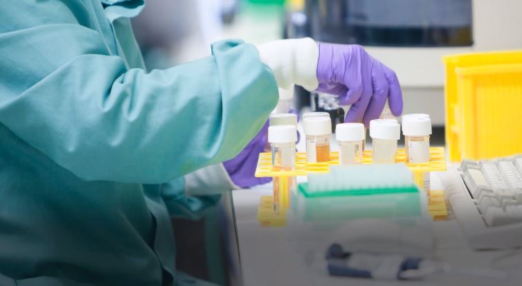 Scientist handling test tubes in a lab
