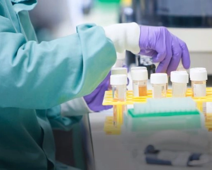Scientist handling test tubes in a lab